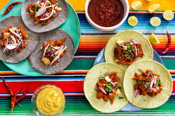 Fresh Mexican tacos on table with chili sauce